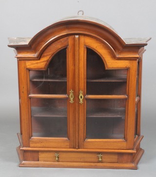 An 18th Century Dutch arch shaped mahogany hanging wall cabinet, fitted shelves enclosed by glazed panelled doors, the base fitted 1 long drawer 36"h x 35"w x 12"d 