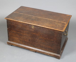 An 18th Century elm trunk with hinged lid and brass drop handles, raised on bracket feet 17"h x 31 1/2"w x 19"d 