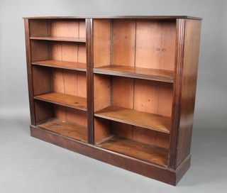 A Victorian mahogany open bookcase fitted adjustable shelves and raised on a platform base, having fluted columns to the sides 45 1/2"h x 60"w x 12"d 