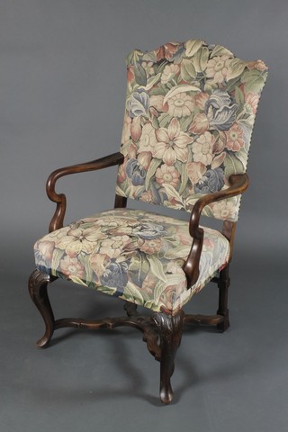 A Queen Anne style walnut open arm chair with X framed stretcher, raised on cabriole supports