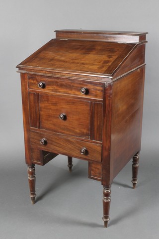 A 19th Century mahogany campaign Davenport wash stand, the back fitted a cistern, the rising lid revealing a blue and white wash bowl (cracked), the base fitted a cupboard above a drawer, 42"h x 23"w x 21 1/2"d