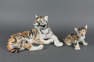 A 20th Century Russian figure of a reclining tigress and cub 