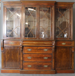 A Victorian mahogany breakfront bookcase, the upper section with moulded cornice, fitted shelves enclosed by astragal glazed panelled doors, the base fitted 1 long secret drawer above 3 long drawers and with 2 drawers to the sides above cupboards, raised on a platform base 87"h x 80"w x 21"d (made up, the top being of a later date to the bottom) 