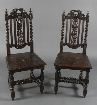 A pair of Victorian Carolean style high back hall chairs with pierced carved backs and solid seats, raised on turned supports with H framed stretcher, both frames are loose