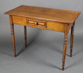 A late Victorian rectangular oak side table fitted a drawer, raised on ring turned supports 29 1/2"h x 37 1/2"w x 18 1/2"d 