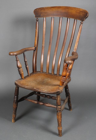 A 19th Century elm stick and bar back Windsor kitchen chair with solid elm seat on turned supports with double framed stretcher