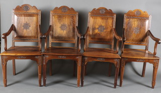A set of 4 Burmese carved hardwood high back open arm throne chairs, raised on square tapering supports 