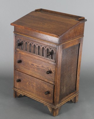 An oak Davenport with sliding top and three-quarter gallery, fitted 3 long drawers, having arcaded decoration and turned handles, raised on bracket feet 31"h x 21"w x 16"d 