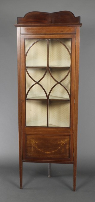 An Edwardian inlaid mahogany corner cabinet with raised back, fitted shelves enclosed by astragal glazed panelled doors, raised on square tapering supports 63 1/2"h x 22"w x 15"d 