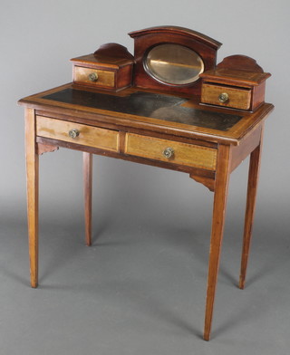 An Edwardian inlaid mahogany writing table, the raised back fitted an oval plate mirror flanked by a pair of drawers with inset writing surface above 2 long drawers, raised on square tapered supports 37"h x 30"w x 17"d 