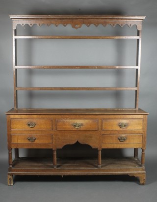 An 18th Century oak dresser, the raised shelved back with moulded cornice and pierced apron, fitted 3 shelves, the base fitted 3 long drawers above 2 short drawers with brass plate drop handles above a cupboard, raised on bracket feet 81 1/2"h x 67"w x 16"d 