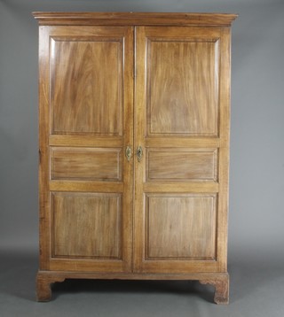 A Jersey walnut press cabinet with moulded cornice, the interior fitted 3 trays enclosed by panelled doors, raised on bracket feet 74 1/2"h x 51 1/2"w x 23"d 