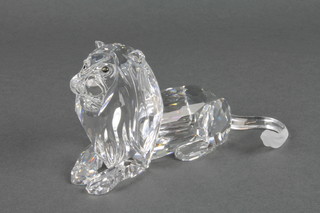 A Swarovski figure of a reclining lion 5 1/4", boxed