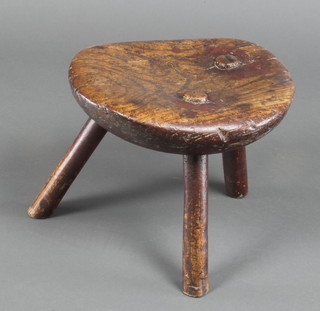 A rustic elm oval 3 legged stool 9"h x 10"w x 9 1/2"d