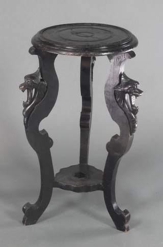 A Victorian circular ebonised 2 tier jardiniere stand raised on griffin style supports 27"h x 14"d