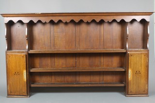 An 18th Century oak dresser back with moulded cornice, fitted 3 shelves flanked by a pair of cupboards 50"h x 89"w x 10"d  