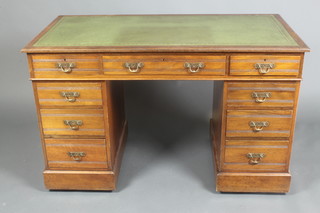 An Edwardian walnut kneehole desk with inset green leather writing surface above 1 long and 2 short drawers, raised on a platform base 28 1/2"h x 48"w x 24"d 
