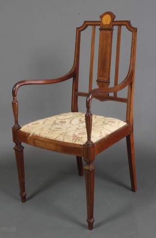 An Edwardian inlaid mahogany stick and rail back open arm chair with upholstered drop in seat, raised on square tapering supports, spade feet 