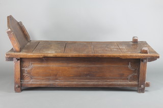 An oak day bed of panelled construction 38"h x 73"w x 32 1/2"d 