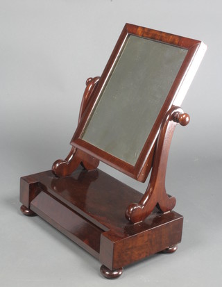 A Victorian rectangular plate dressing table mirror contained in a mahogany swing frame, the base fitted a drawer, raised on bun feet 21 1/2"h x 16 1/2"w x 9"d