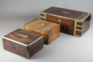 A Victorian rectangular rosewood and brass banded trinket box with hinged lid 5"h x 11"w x 9"d, together with a Victorian mahogany brass banded writing slope complete with candle sconces and glass inkwell 7"h x 20"w x 10 1/2"d and a Victorian inlaid mahogany writing slope with hinged lid 5 1/2" x 12" x 8 1/2" 