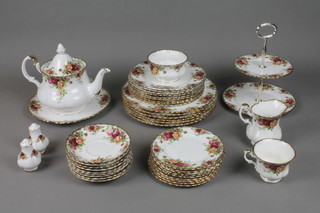 A Royal Albert Old Country Roses part tea and dinner service comprising a teapot, 3 tea cups, cream jug, sugar bowl, 2 tier cake stand, salt pepper, 9 saucers, 9 side plates, 9 medium plates and 6 dinner plates