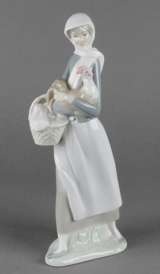 A Lladro figure of a girl holding a chicken 10"