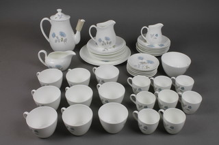 A Wedgwood Ice Rose tea and coffee set comprising coffee pot, cream jug, milk jug, 8 coffee cups, 8 saucers, 8 tea cups, 8 saucers, 8 sandwich plates, 1 large plate, a sauce boat, sugar bowl and slop bowl 