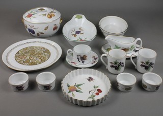 A Royal Worcester Evesham dinner service comprising tureen and cover, flan dish, 4 ramekins, 5 mugs, 1 saucer, sauce boat and stand, oval meat dish and tureen base together with a decorative wall plate 