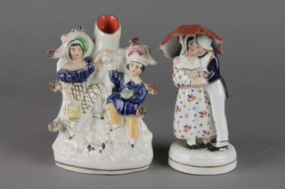 A 19th Century Staffordshire figure group of a courting couple beneath an umbrella 6", ditto spill vase 6" 