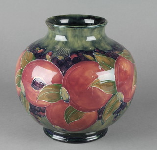 A Moorcroft baluster vase decorated with pomegranate design on a green ground with impressed and signature marks 7 1/2" 