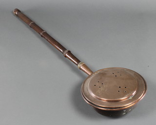 An 18th/19th Century copper warming pan with pierced lid and turned wooden handle