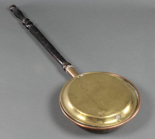 An 18th/19th Century copper and brass warming pan with turned ebonised handle 