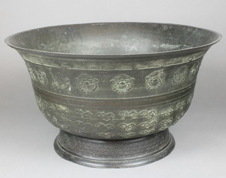 A 19th Century Chinese archaistic bronzed bowl with flared neck with key pattern rim and a band of grotesque masks above a field of clouds with lappet base 21" diam