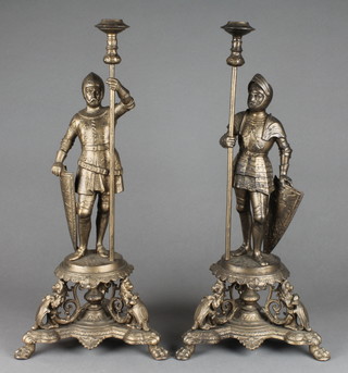 A pair of Victorian gilt painted spelter candlesticks in the form of knights holding lances, raised on pierced bases 17"  
