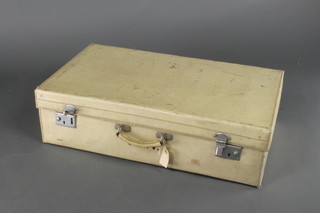 A parchment suitcase with chrome mounts 7"h x 26"w x 15"d
