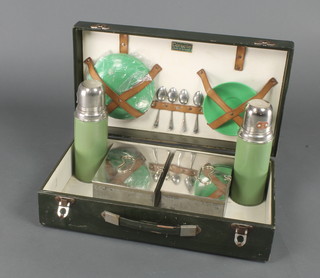A Coracle picnic hamper containing 2 Thermos flasks, 2 square sandwich boxes, 4 chrome teaspoons, 3 green plastic saucers and 4 ditto plates 