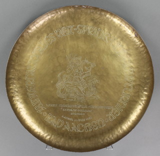 A circular engraved brass charger decorated St George slaying a dragon, marked Lieutenant Colonel J S Colings 1948, 22 1/2"