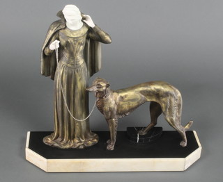 An Art Deco spelter figure group of a standing lady with Afghan hound, raised on a shaped marble base 16"h x 21"w