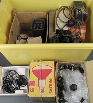 A yellow plastic crate containing various valves, a head and breast set, various ham radio equipment