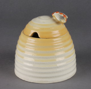 A Clarice Cliff honey pot in the form of a beehive with bee handle 4" 