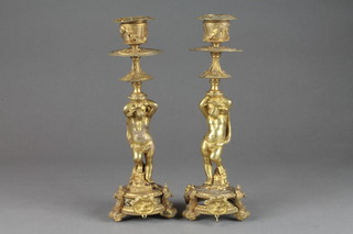 A pair of 19th Century gilt ormolu candlesticks in the form of standing cherubs 