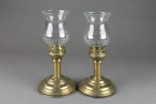 A pair of brass candlesticks with bell shaped shades 10" 