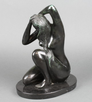 S Strempler, a patinated bronze figure of a crouching girl, raised on an oval marble base, 13"h 