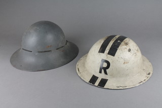 A Second World War white painted rescue party helmet, liner missing together with a Fire Watcher's helmet 