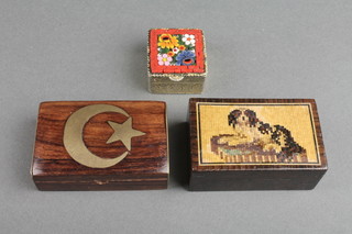 A Victorian Tunbridge ware box decorated a figure of a seated dog 1"h x 2 1/2"w x 1"d, a Turkish? hardwood box with hinged lid inlaid a crescent moon 1" x 2" x 1", a square gilt metal box the lid inlaid 