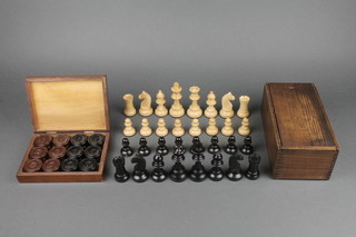 A Staunton ebonised and turned light wood chess set, together with a black and brown Bakelite drafts set 