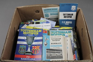 A plastic crate containing a collection of various Tottenham Hotspurs programmes