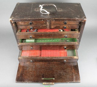 A tool makers chest containing various red and green Meccano 