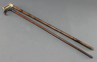 A 19th Century walking stick with stag horn handle and silver mount and 1 other stick with horn handle and silver mount